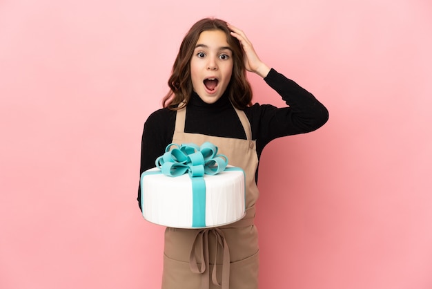 Little Pastry chef holding a big cake isolated