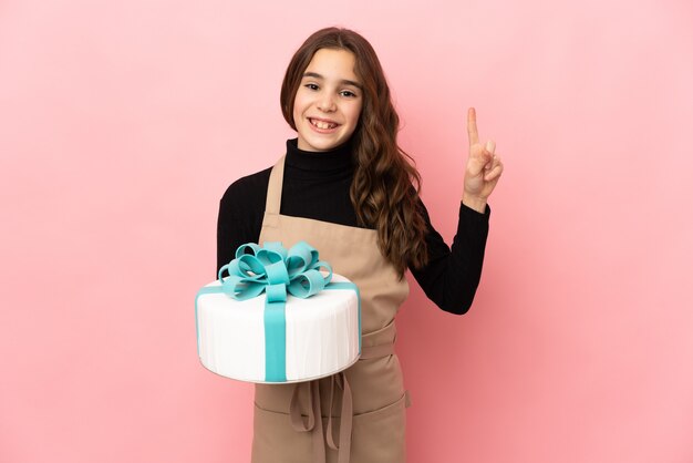 Little Pastry chef holding a big cake isolated