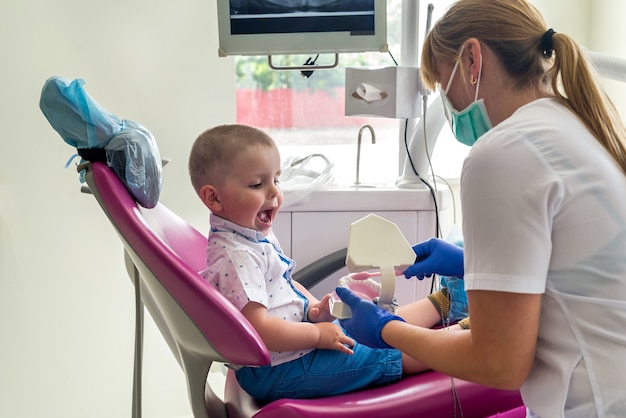 Little patient looking how to clean teeth right