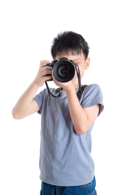 Little photographer taking photo over white background