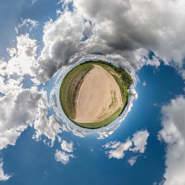 Little planet Spherical view in a field in beautiful day with nice clouds