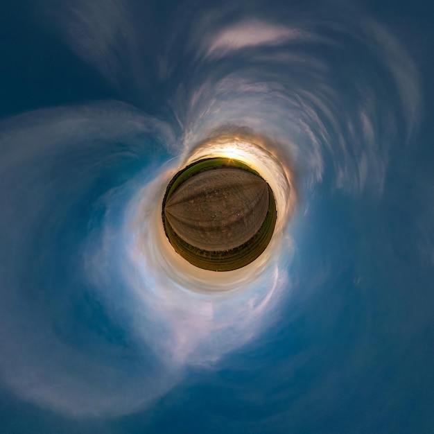 Little planet transformation of spherical panorama 360 degrees\
spherical abstract aerial view in field with awesome beautiful\
clouds curvature of space