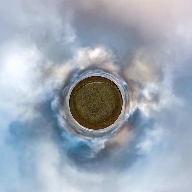 Little planet transformation of spherical panorama 360 degrees Spherical abstract aerial view in field with awesome beautiful clouds Curvature of space