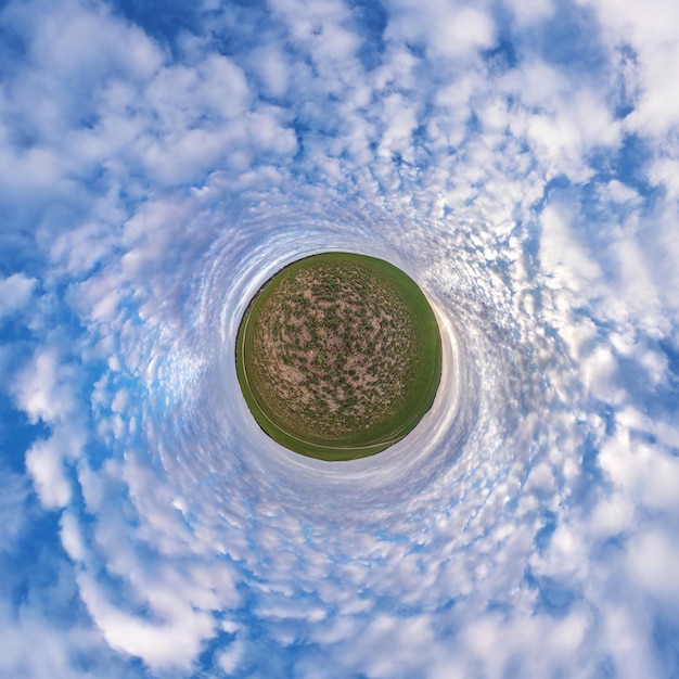 Little planet transformation of spherical panorama 360 degrees Spherical abstract aerial view in field with awesome beautiful clouds Curvature of space