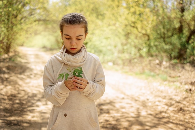 Bambina graziosa in passeggiata nel soleggiato parco primaverile