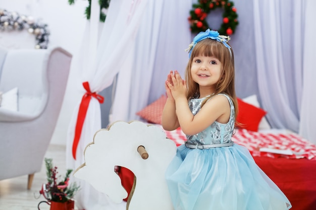 Little princess in her dress. The concept of Christmas.