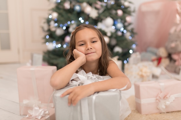 Little princess with Santa's present for Christmas