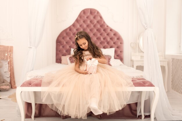 Little princess with Santa's present for Christmas