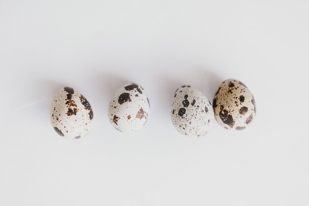 little quail eggs on a light smooth background in closeup