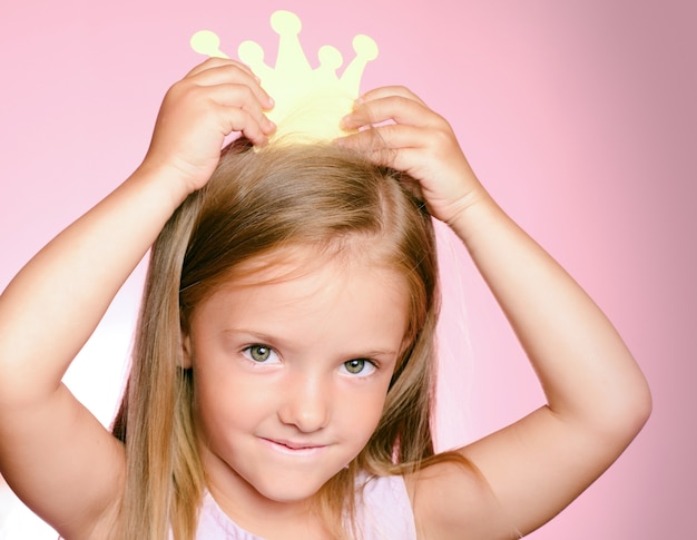 Little queen child girl with gold crown.