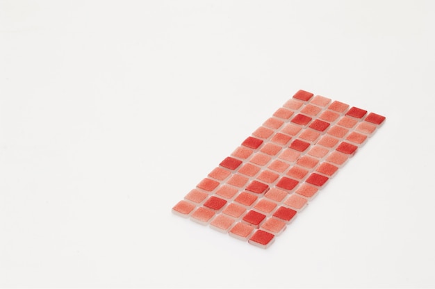 Little red ceramic tile on a white background, majolica. for the catalog