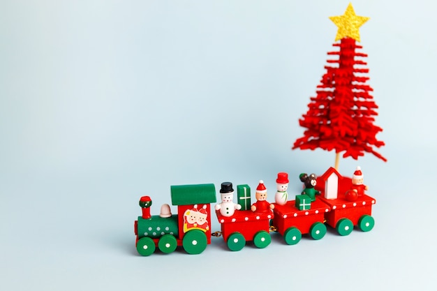 Little red christmas toy train on blue background