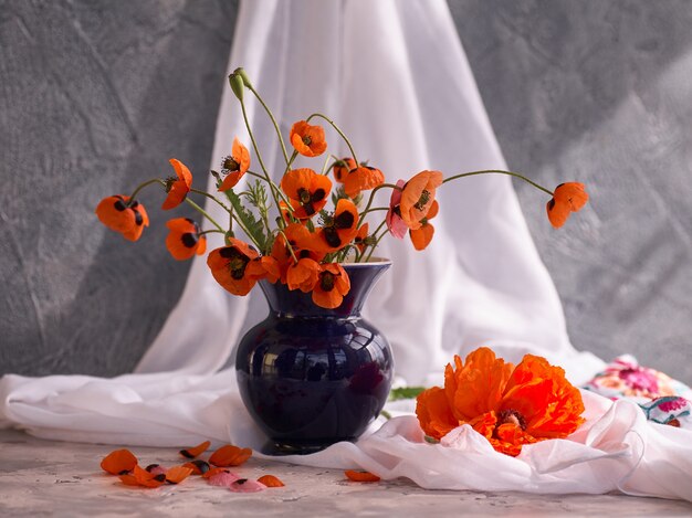 A Little Red Poppies Bouquet in blue ceramic vase