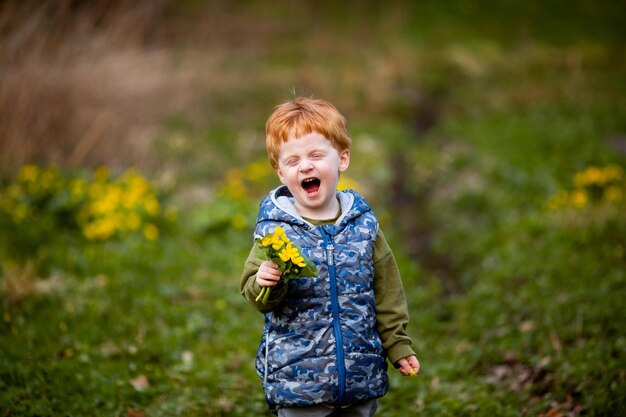 Little redhaired boy smiles and enjoys life