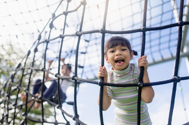 Photo little school kids climbing in the school playground