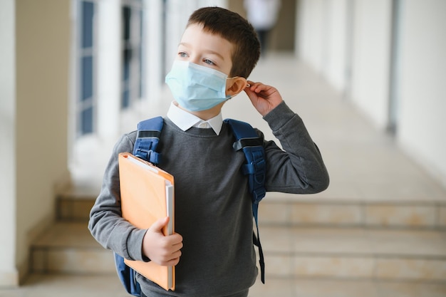 Little schoolboy wearing a mask during an outbreak of corona and influenza virus protection against diseases for children Mask for the prevention of coronavirus