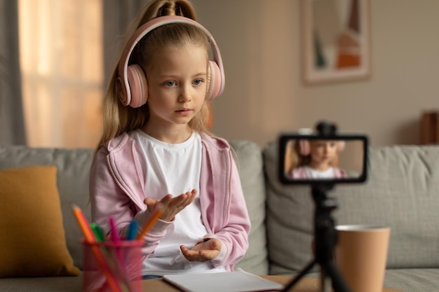 Little Schoolgirl Learning Online Video Calling Via Cellphone At Home