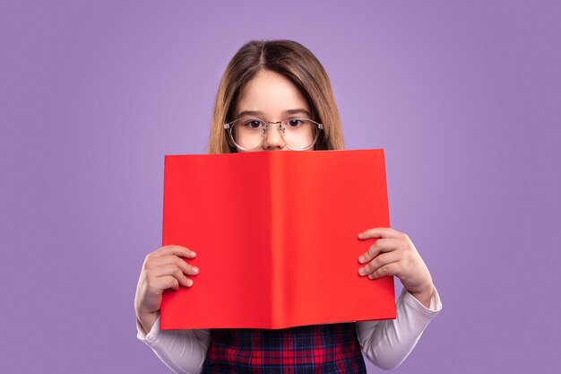 Little schoolgirl with red book