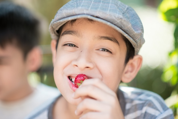 Little sibling boy eating and fighting while eat strawberry