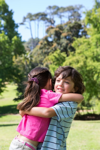 Little siblings hugging each other