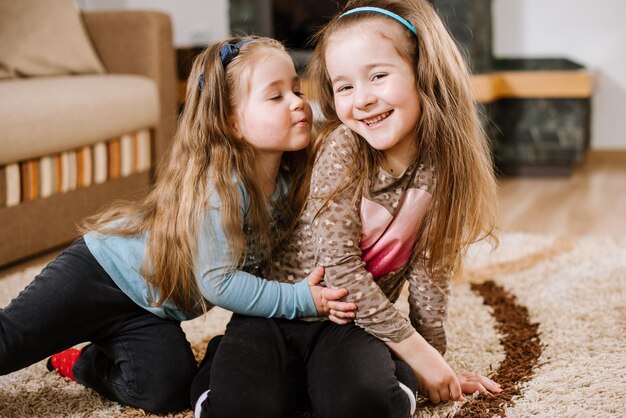 Little sisters playing and have fun at home