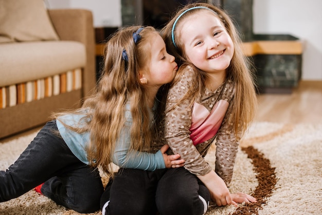 Little sisters playing and have fun at home