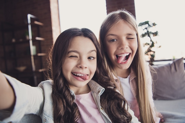 Little sisters posing together on the couch