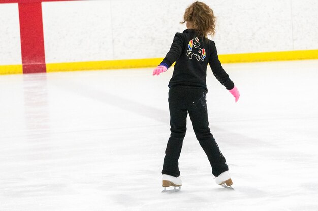 Little skater practicing her elements at the morning figure skating practice.