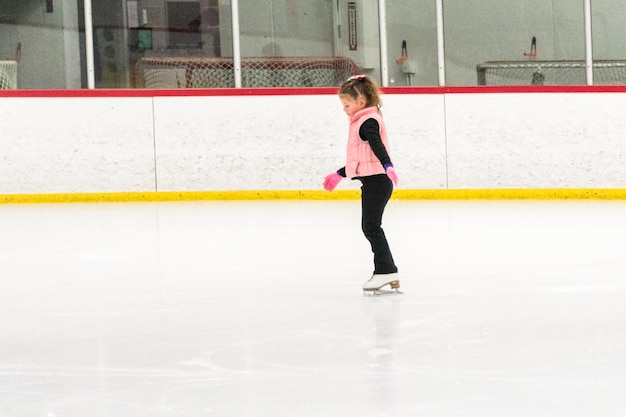 Little skater practicing her elements at the morning figure skating practice.