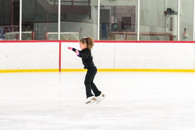 Little skater practicing her elements at the morning figure skating practice