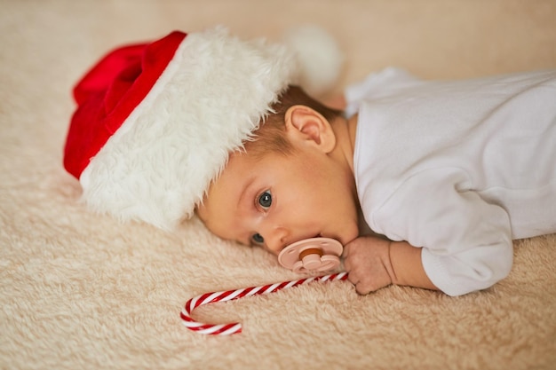 Little sleeping newborn baby wearing Santa hat