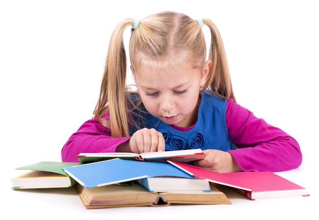 little smart girl holding a book and reading it on a white background