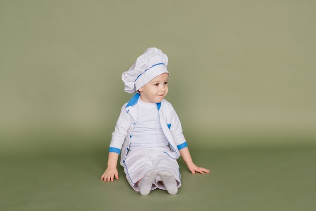 Little smiling cooker with bread and bagels, isolated