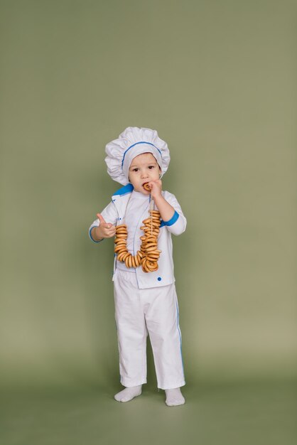 Little smiling cooker with bread and bagels, isolated 