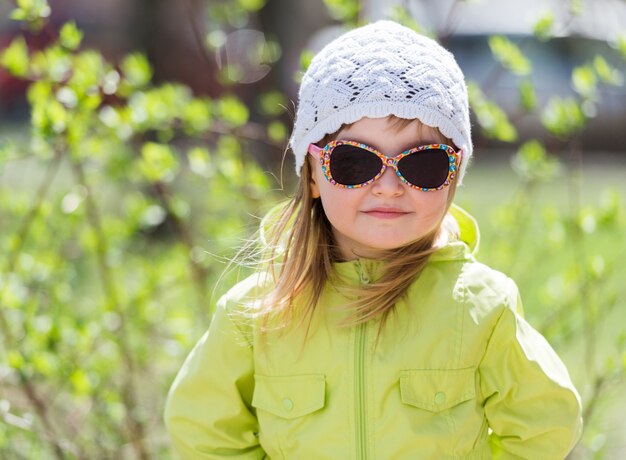 Little smiling girl in sunglasses