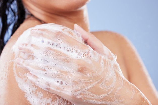 A little soap is all you need Shot of an unrecognizable woman taking a shower against a blue background