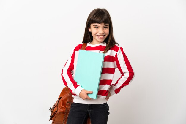 Little student girl isolated on white background posing with arms at hip and smiling