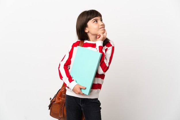 Little student girl isolated on white background thinking an idea while looking up