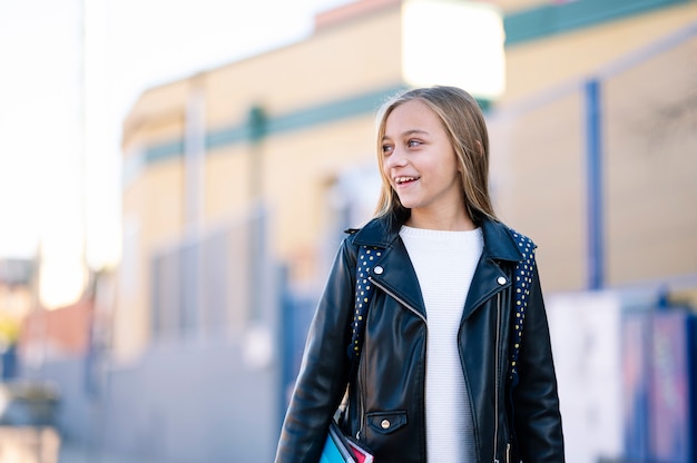 Little student girl on the way to school