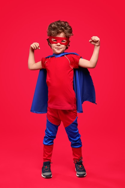 Photo little superhero showing muscles