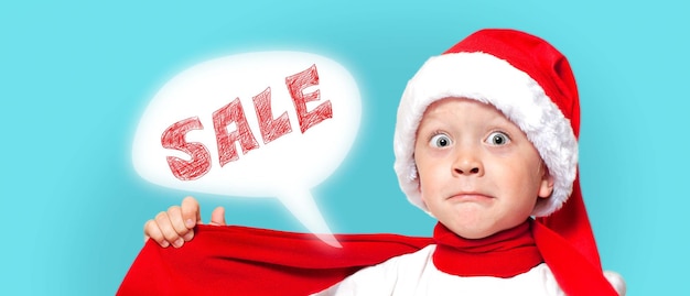 A little surprised boy in a Santa hat announces of sales