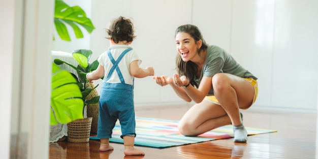 Little toddler children with first walk step with stairs at home, small baby person are happy to play and learn to crawling with family, cute infant boy having fun and childhood care