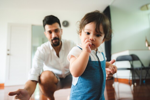 Little toddler children with first walk step with stairs at home, small baby person are happy to play and learn to crawling with family, cute infant boy having fun and childhood care