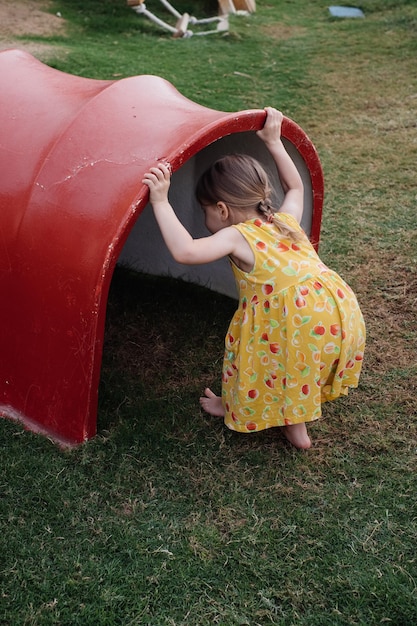 Little toddler girl playing on the kids playground