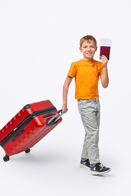 Little traveler with luggage and tickets