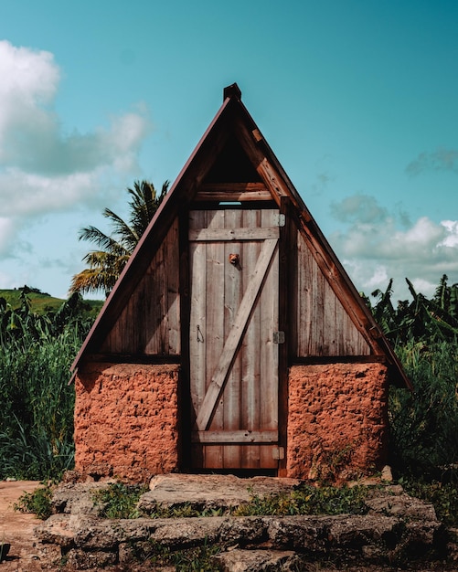 Little triangle roof rustic old cabin of a farm in the field from puerto rico