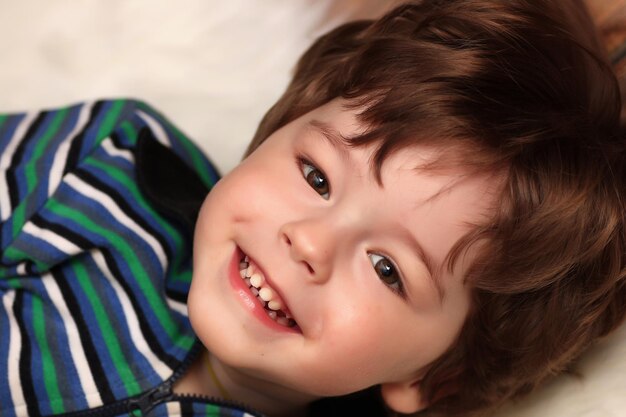 Little twins are lying on the floor and smiling