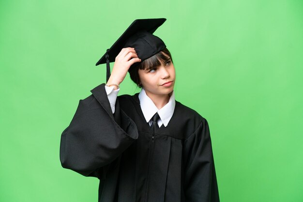 Little university girl over isolated background having doubts and with confuse face expression