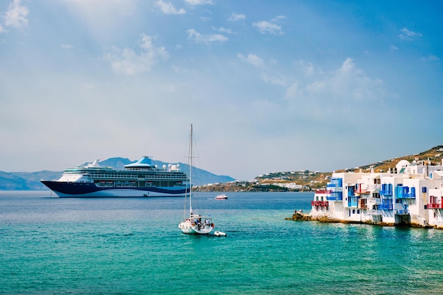 Little Venice houses in Chora Mykonos town with yacht and cruise ship Mykonos island Greecer