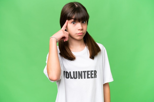 Little volunteer girl over isolated background thinking an idea